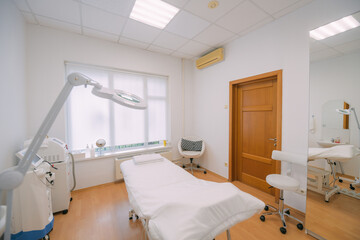 The interior of the massage and cometology salon, massage table. Nobody.