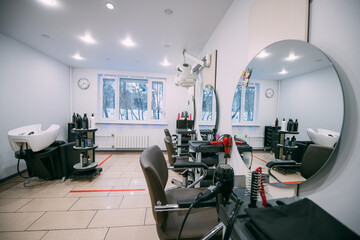 Modern interior of a hairdressing salon. Nobody. Bright large salon for professional hair care and beauty treatments.