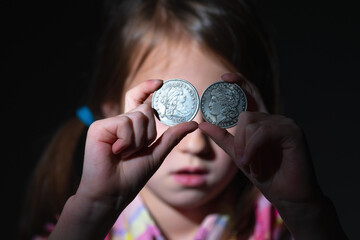 US Dollar coins in front of eye as symbol of love to money and strong motivation.