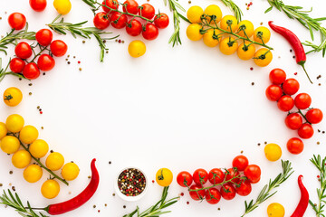 Yellow and red tomatoes, hot peppers, rosemary and spices on a white background, food background, top view, copy space