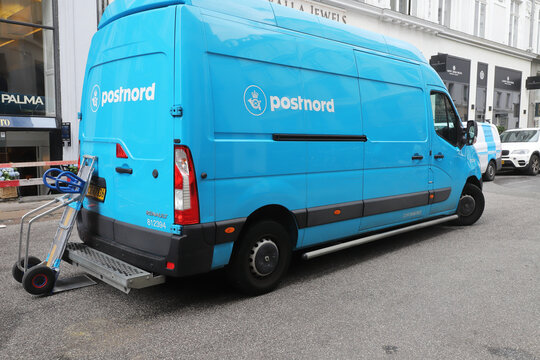 Copenhagen, Denmark - June 14, 2022: Rear view of a blue Postnord parcel delivery van.