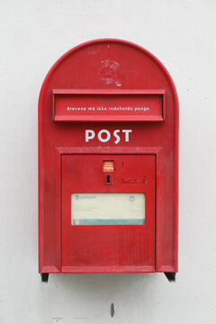 Copenhagen, Denmark - June 14, 2022: Red classic Danish post box operated by Postnord.