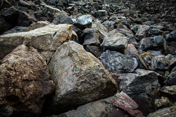 Texture of natural gravel. Stones with a rough textured surface and lichen, close-up.