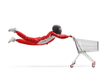 Car racer with a helmet flying and holding a shopping cart