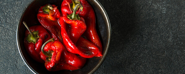 bowl with baked bell peppers on dark table