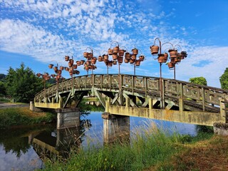 Arched footbridge with flower pots