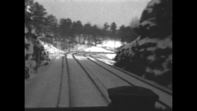 View from a Train 1933 - Views of a snow covered landscape from the caboose of a traveling train in 1933.