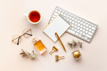 Home work place table with golden colored office supplies. Overhead view