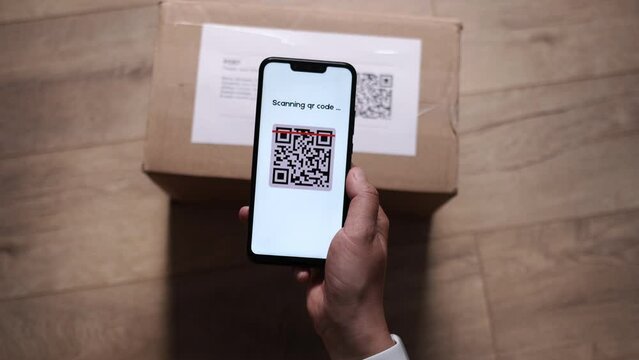 CloseUp POV of Female Holding QR Code Scanner on Smartphone App, Scanning Parcel Bar Code. Online Retail Shop Order in Dropshipping Delivery Service Warehouse. QR Code Reader with Success Approval.