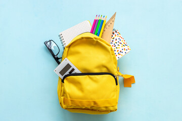 Naklejka premium School backpack with school items and students equipment, top view