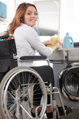 happy disable woman doing a washing machine