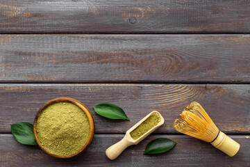 Green matcha with bamboo whisk. Powder in wooden bowl