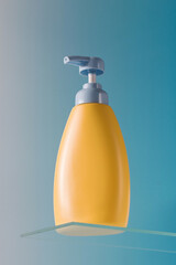  Dispenser bottle of yellow color baby liquid soap on a glass shelf on a blue background. Cosmetics for children's skin.