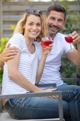 couple sitting on outdoor seat together