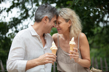 affectionate senior couple holding ice-creams