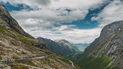Trollstigen, Andalsnes, Norway. Stigfossen Waterfall Near Serpentine Mountain Road Trollstigen. Famous Norwegian Landmark And Popular Destination. Norwegian County Road 63 In Summer Day. 4K.