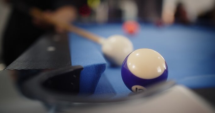 Close up person enjoying playing billiard break shot Pool Balls with numbers on a pool table, Sports game of billiards	
