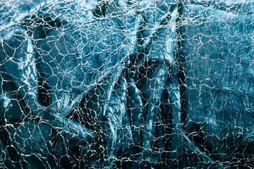 Blue abstract texture background. Silk material looks like clear water waves in sunshine rays, through cracked glass surface. Beautiful, creative, stylish backdrop for design. Selective soft focus
