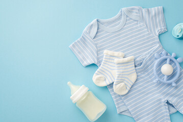 Baby accessories concept. Top view photo of blue infant clothes socks shirt panties milk bottle rattle and pacifier on isolated pastel blue background - obrazy, fototapety, plakaty