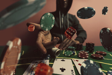 Gambler man hands pushing large stack of colored poker chips across gaming table for betting - obrazy, fototapety, plakaty
