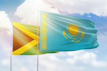 Sunny blue sky and flags of kazakhstan and jamaica