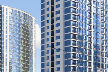 Fototapeta na wymiar Contemporary high-rise apartment buildings, frame-block construction, ventilated glass facade