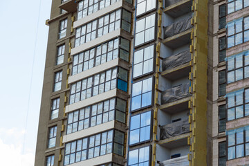 Contemporary high-rise apartment buildings, frame-block house under construction