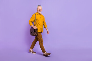 Full size profile side photo of mature man go hold briefcase manager isolated over violet color background