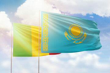 Sunny blue sky and flags of kazakhstan and mali