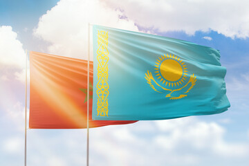 Sunny blue sky and flags of kazakhstan and morocco