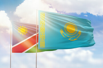 Sunny blue sky and flags of kazakhstan and namibia
