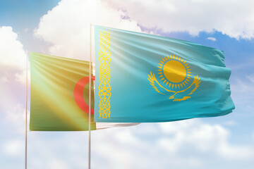 Sunny blue sky and flags of kazakhstan and algeria