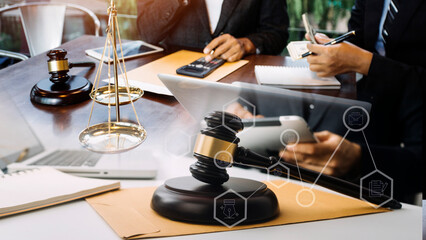 Justice and law concept.Male judge in a courtroom with the gavel, working with, computer and docking keyboard, eyeglasses, on table in morning light