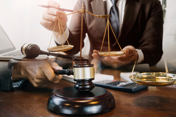 Justice and law concept.Male judge in a courtroom with the gavel, working with, computer and...