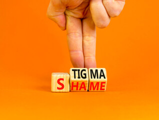 Stigma or shame symbol. Concept words Stigma or Shame on wooden cubes. Businessman hand. Beautiful...