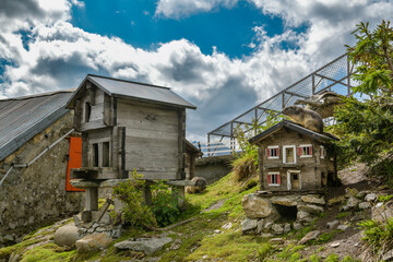 Fototapeta na wymiar Small wooden houses accommodating marmots on top of Grimselpass