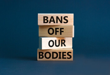 Bans off our bodies symbol. Concept words Bans off our bodies on wooden blocks on a beautiful grey table grey background. Women rights concept. Business social issues and bans off our bodies concept.