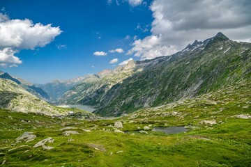 Fototapeta na wymiar View on beautiful mountains and small lake in Grimselpass in Switzerland