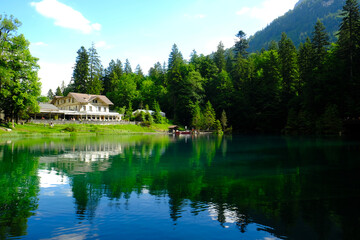 Fototapeta na wymiar Selective focus of house at Blausee Lake with reflection. The myth of this place is the lake water are from women cry.