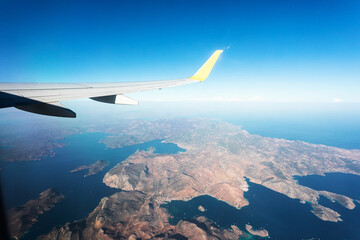Obraz na płótnie Canvas View from the plane window to the Turkish mountains in the Fethiye region and the blue sea