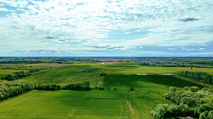 Fototapeta na wymiar Winter has passed and now color is back in the land! Green trees and grass and a blue sky!