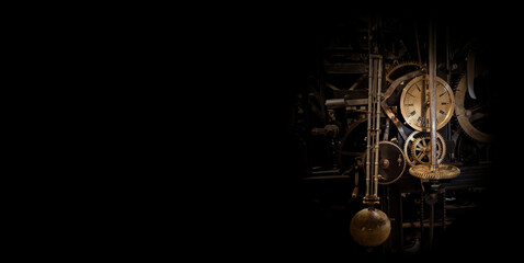Fototapeta The mechanism of an old antique watch in the dark. Surrounded by black space. obraz