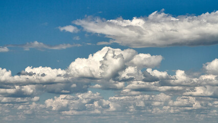 Fototapeta premium White porous clouds on blue sky, sky with clouds, cloudy landscape