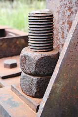 Old rusty bolts and nuts on the base of the tower frame.
