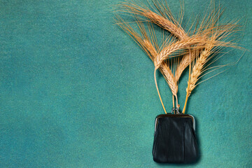 Purse with ripe ears. Concept of wheat price growth