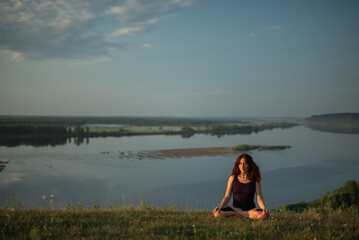 Yoga practice and meditation outdoor. Girl in the park