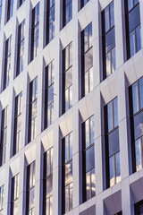 Office facade with windows and sky reflection