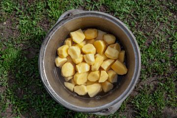 Peeled and cut potatoes in camping pot