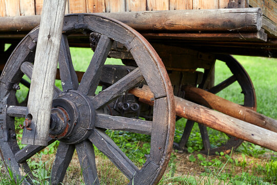 Wooden wheel of vintage cart close up