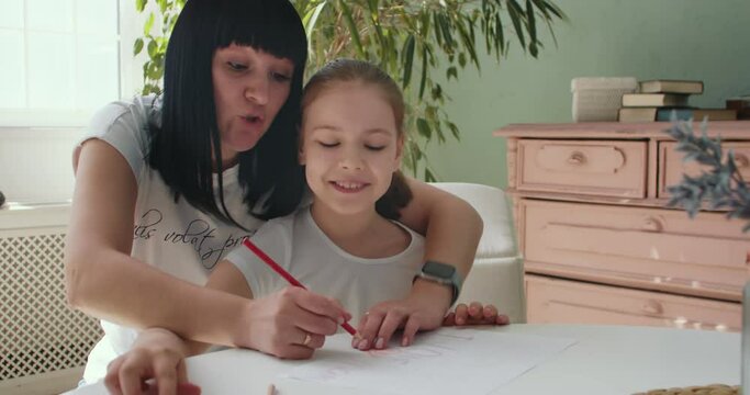 Daughter with mom painting draw pencil diy postcard in living room